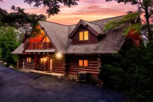 a log cabin with a porch and a deck at Great Alpine - 4 KingSuites- December Deals-Views-Hot Tub-FirePit-GameRm in Gatlinburg +77 photos