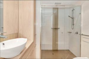 Ένα μπάνιο στο Lovely 1BR Apartment On Morphett with Pool & Wi-Fi