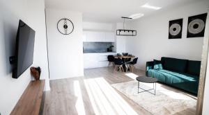 a living room with a green couch and a table at Downtown28 apartment in Poprad