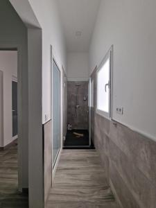 a hallway of a bathroom with a shower and a window at Alojamientos Agaete Pueblo Nº13 in Agaete