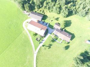 an aerial view of a house in a field at Ferienparadies Fuchsloch in Waakirchen