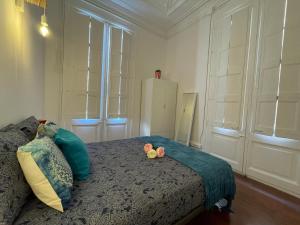a bedroom with a bed with two teddy bears on it at Centric Rooms Ghotic in Barcelona
