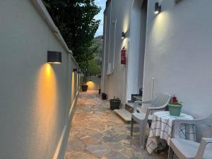 an alley with chairs and tables on a building at Tanias House in Platanias