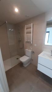 a bathroom with a toilet and a shower and a sink at New beside Sitges with pool beside beach in Vilanova i la Geltrú