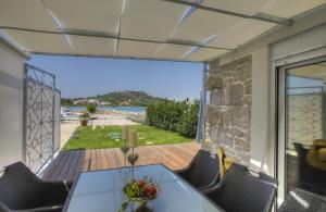 a dining room with a table and a view of the ocean at Waterfront Home - Villa Sailor's Delight in Betina