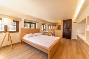 a large bedroom with a bed and a table at Angela's Guest House by AegianKazarte in Egina
