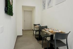 a dining room with two tables and chairs at Dimora Savoia in Naples