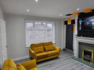a living room with a couch and a fireplace at Bridgepay Modern 4 bedroom House in Cumbria - Whitehaven - Free Parking in Whitehaven