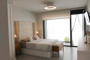 a bedroom with a bed and a large window at Sunrise & Pool Mairena Metro in Mairena del Aljarafe +18 photos