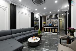 a living room with a couch and a piano at Beryl Signature Hotel & Travel in Hanoi