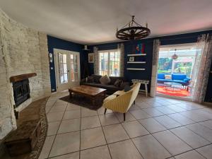 a living room with a couch and a fireplace at Lovely House Near Geneva in Prévessin