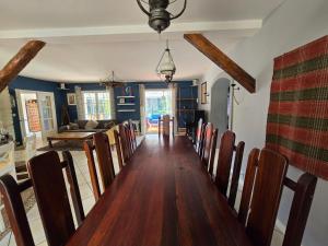 a dining room with a long table and chairs at Lovely House Near Geneva in Prévessin