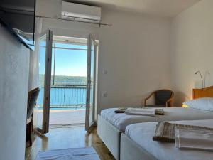 a bedroom with two beds and a view of the ocean at Seacoast apartments MELIHA in Neum