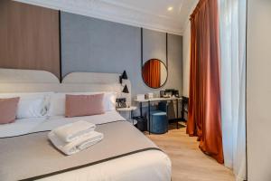 a bedroom with a bed with towels on it at Soho Boutique Turia in Valencia +62 photos
