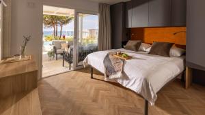 a bedroom with a large bed and a balcony at Terra Park Phalaris in Novalja