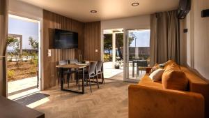 a living room with a couch and a table at Terra Park Phalaris in Novalja