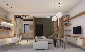 a living room with white furniture and a tv at Athos Villas in Ouranoupoli