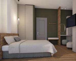 a bedroom with a bed and a flat screen tv at Athos Villas in Ouranoupoli