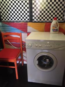 a washing machine and a chair in a room at Apartment Cimbora, Salara farmhouse in Koper