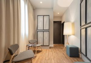 a living room with chairs and a table at TOC Hostel Malaga in Málaga
