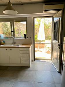 a kitchen with a sink and a sliding glass door at Nicole's Cave Studio in Pylos