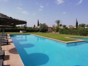a large blue swimming pool in a resort at VILLA CHEZ IMANE avec piscine chauffée a Orangeraie Dyar Shemsi in Riaïna