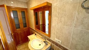 a bathroom with a sink and a mirror at Las perlas VYBDenia in Denia +35 photos