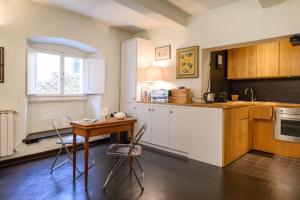 a kitchen with a table and chairs and a sink at Pitti Cozy House in Florence