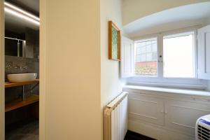a bathroom with a window and a radiator at Pitti Cozy House in Florence +17 photos