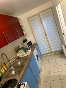 a kitchen with a sink and a washing machine at Chambre meublée cuisine à 20 minutes de Disneyland in Champs-Sur-Marne +1 photo
