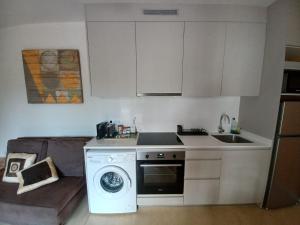 a kitchen with a stove and a sink and a microwave at Travertí de Banyoles in Banyoles +3 photos