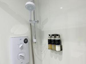 a room with a white refrigerator with a fan and spices at Marina Apartments 2 in Fort William +15 photos