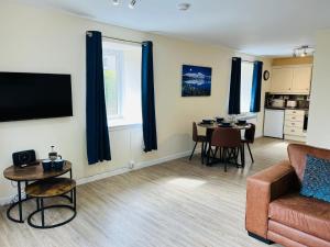 a living room with a couch and a table at Marina Apartments 2 in Fort William