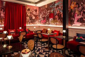 a restaurant with red chairs and tables in a room at Upon Angels - Adults Only in Lisbon