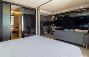 a room with a bed and a living room at Seaphere Pattaya Hotel by Elite Suites in Na Jomtien +51 photos