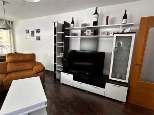 a living room with a large television and a couch at Casa Vila in Riópar