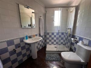 a bathroom with a sink and a toilet and a shower at Casa Vila in Riópar +7 photos