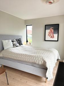a bedroom with a bed and a picture on the wall at The Architects Home in Billund
