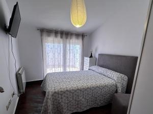 a bedroom with a bed and a window at Casa Vila in Riópar