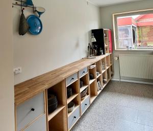 a kitchen with a wooden counter with shelves at The Architects Home in Billund +13 photos
