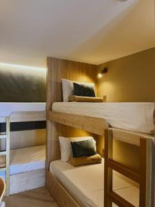 a room with three bunk beds in it at Xen By Balai Norte in san juan la union +41 photos