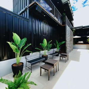 a group of benches and tables on a patio at Xen By Balai Norte in san juan la union