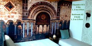 a room with a bed in front of a brick wall at La Couleur du Temps in Couiza