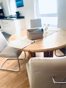 a wooden table with two chairs and a wooden table at Apartment Charly in Steinbeck in Recke +7 photos