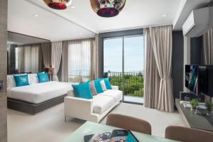 Postel nebo postele na pokoji v ubytování Cross Vibe Pattaya Seaphere + 37 fotografií