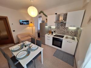 a small kitchen with a table and a table and a kitchen at La casa di Nonno Renzo in Acceglio