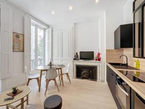a kitchen with a table and chairs and a fireplace at Cosy appartement, Lyon Centre Capucins 1 in Lyon +5 photos