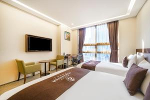 Gloucester Hotel Incheon客房内的一张或多张床位