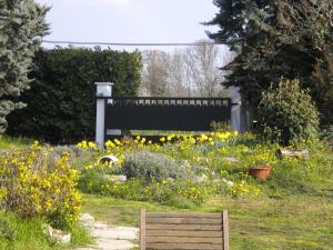a wooden bench in a field of flowers at Appart Nord in Beaurepaire