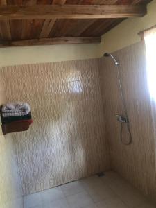 a bathroom with a shower with a shower head at Soanala in Moramanga